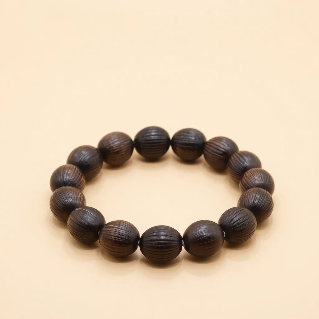 A carved açaí seed bracelet on a light background